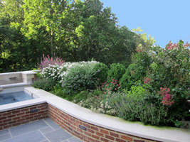 Long blooming, mostly midseason perennials add vibrancy to a spa, brick seating/retaining wall and bluestone pavilion overlooking the Ohio River.  Where open views from the home were important, slower, lower growing plants were chosen. 