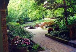 A tranquil front courtyard garden with urns and a built-in water garden.