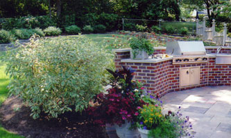Rear patio walk with built in grill, counter top, herb garden & other container gardens.