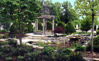 Two level water garden with crossing bridge to summer house (Manor House, Mason Oh).