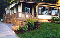 Two entrances are complemented with new steps, walls, and decking across the front of this Michigan lake home.